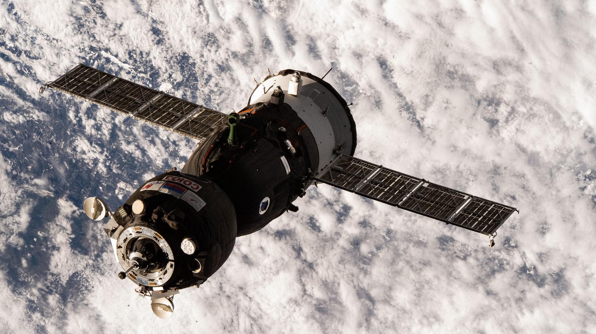 Three Crewmates Aboard Soyuz Approaching Station for Docking